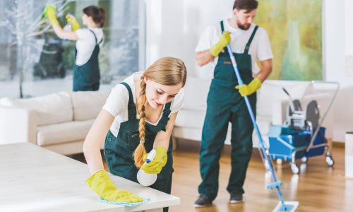 Cleaning service employees with professional equipment cleaning a private home after renovation